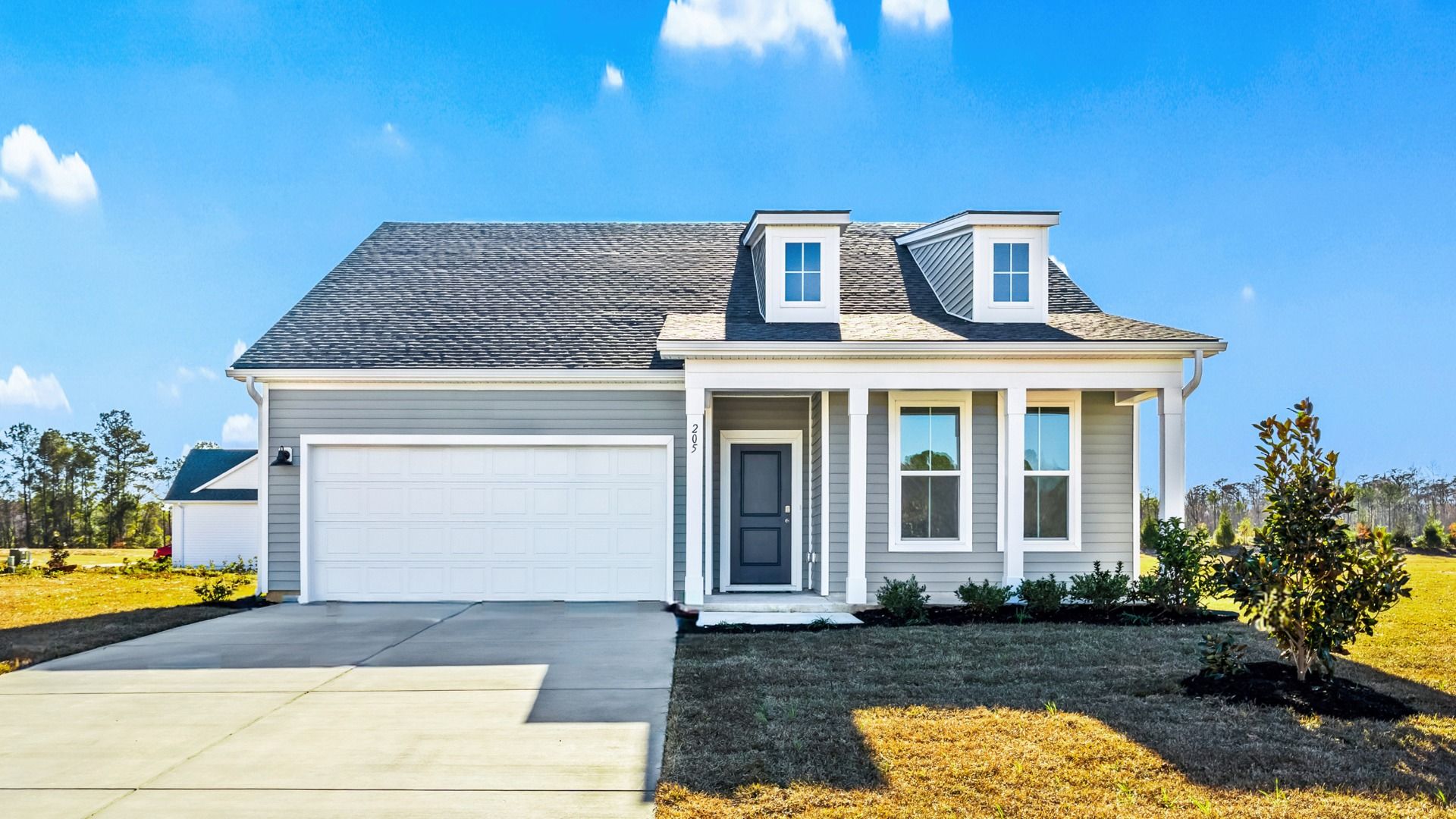 Easton Elevation 4 at Chestnut Farms in Longs, SC, showcasing dormer windows, stylish exterior, and spacious two-car garage