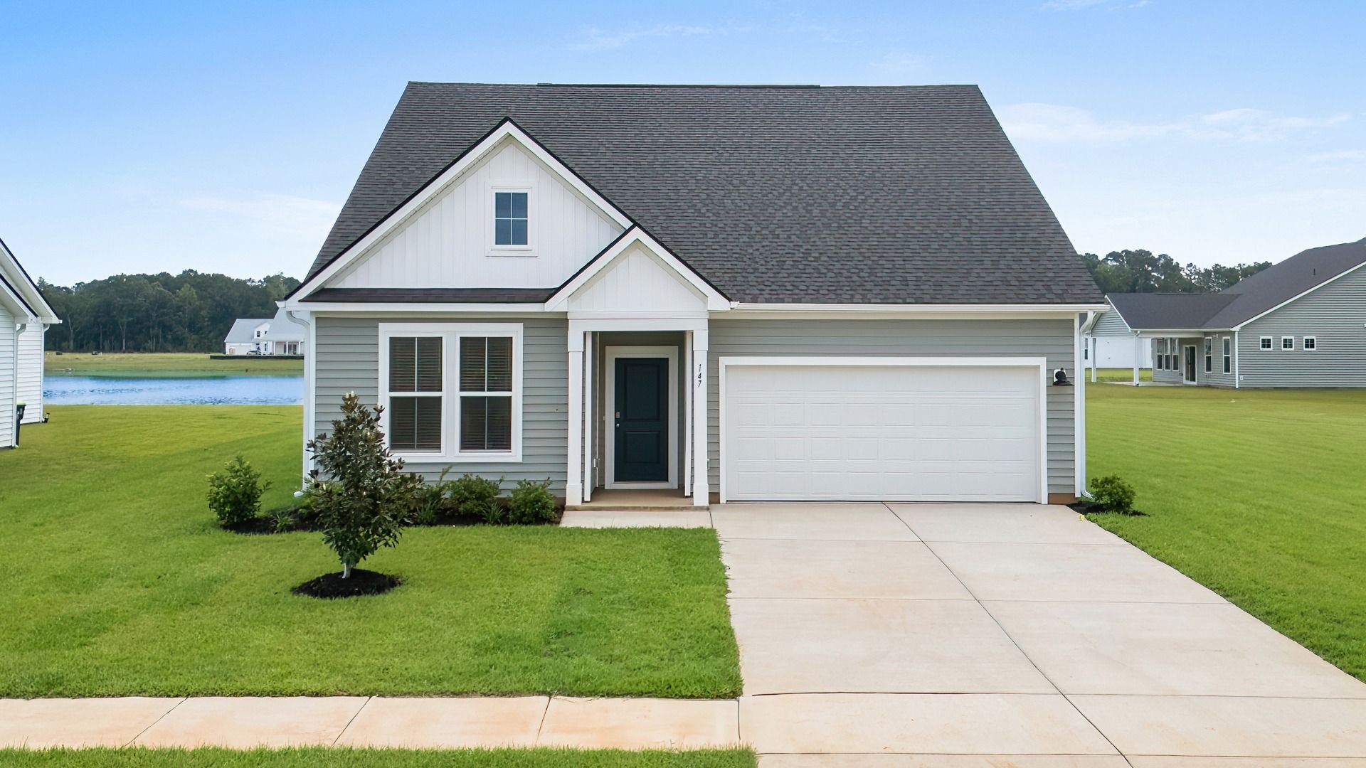Avondale Elevation 2 at Chestnut Farms in Longs, SC featuring charming front porch, gable roofline, and spacious driveway