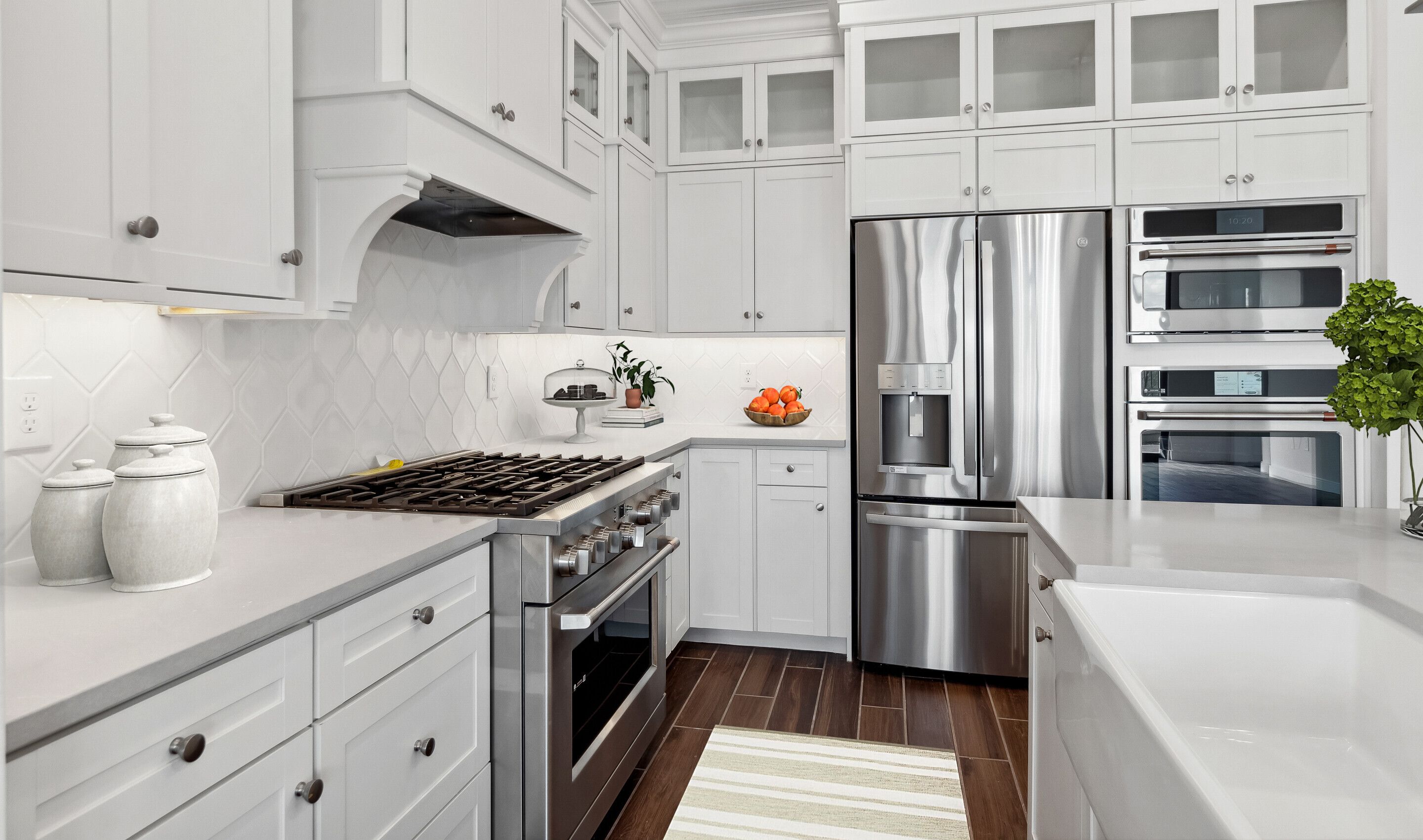 Kitchen with glass upper cabinets and hexagonal backsplash