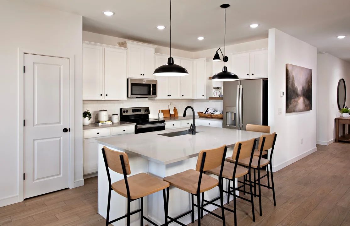 Kitchen with pendant lighting and floating shelves
