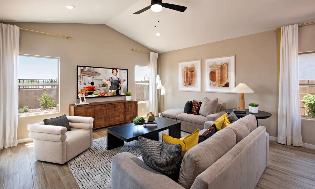 Great room with vaulted ceiling and ceiling fan