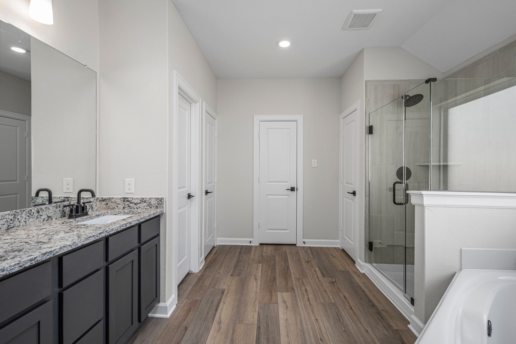 The master bathroom has a large vanity and step in shower!
