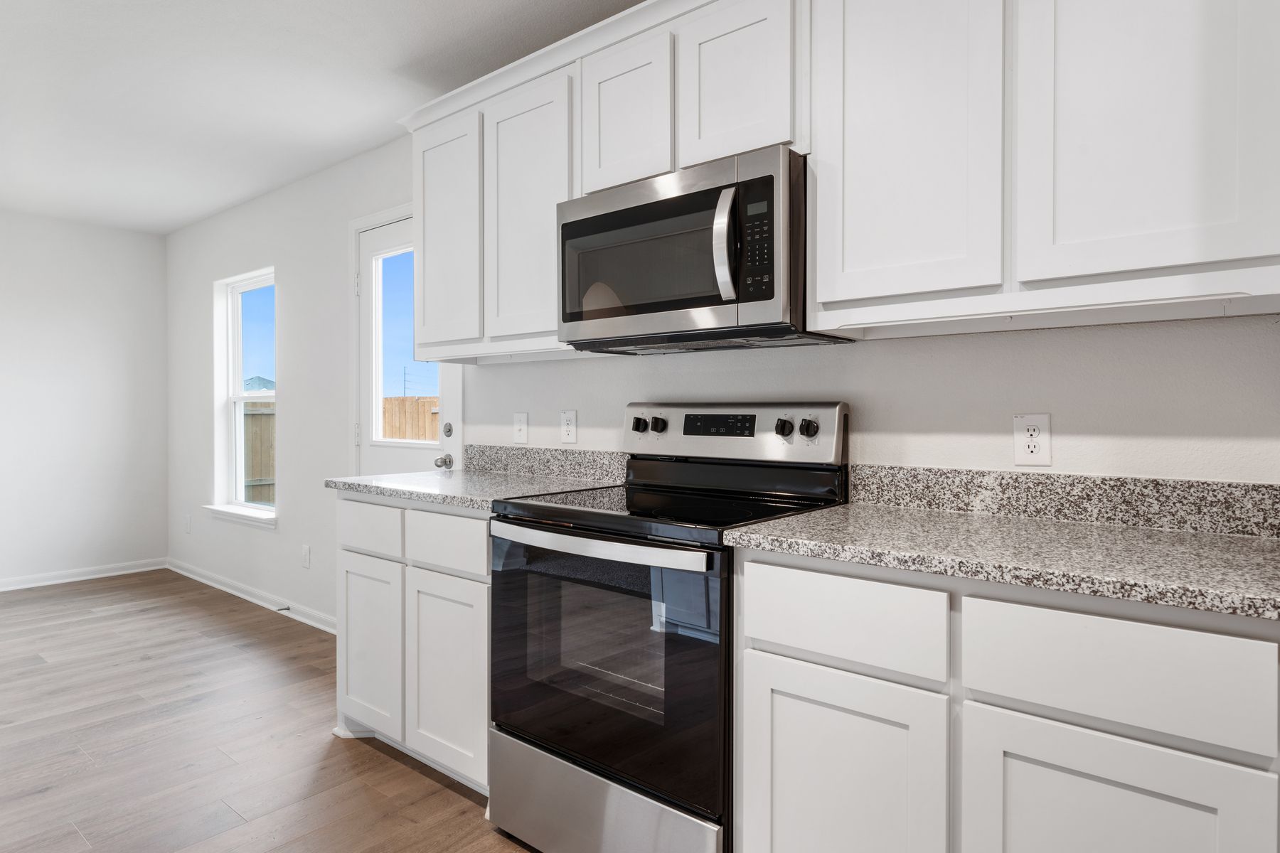 The kitchen of the Reed has beautiful, white wood cabinets.