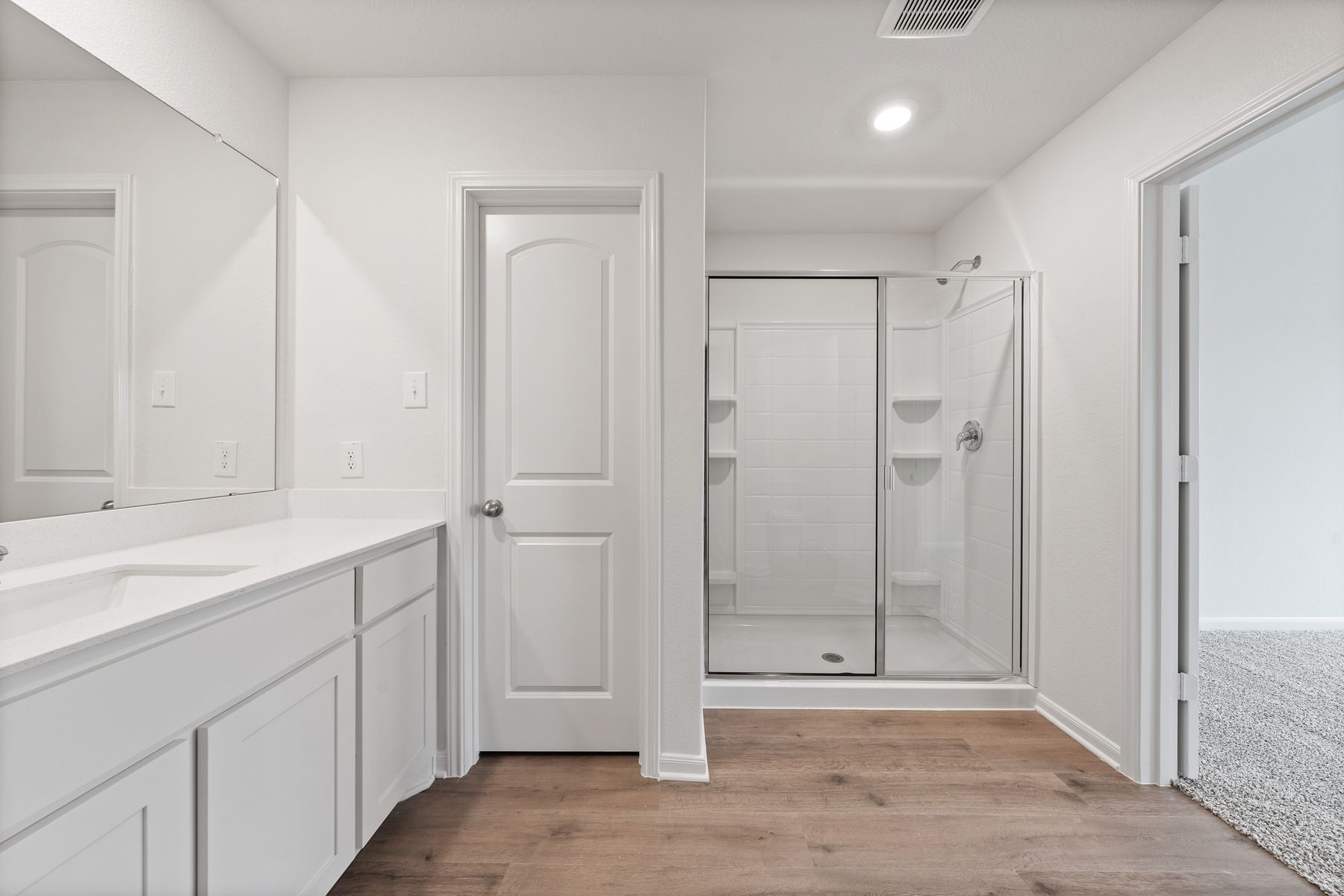 The master bathroom of the Reed  has a large walk-in, glass shower.