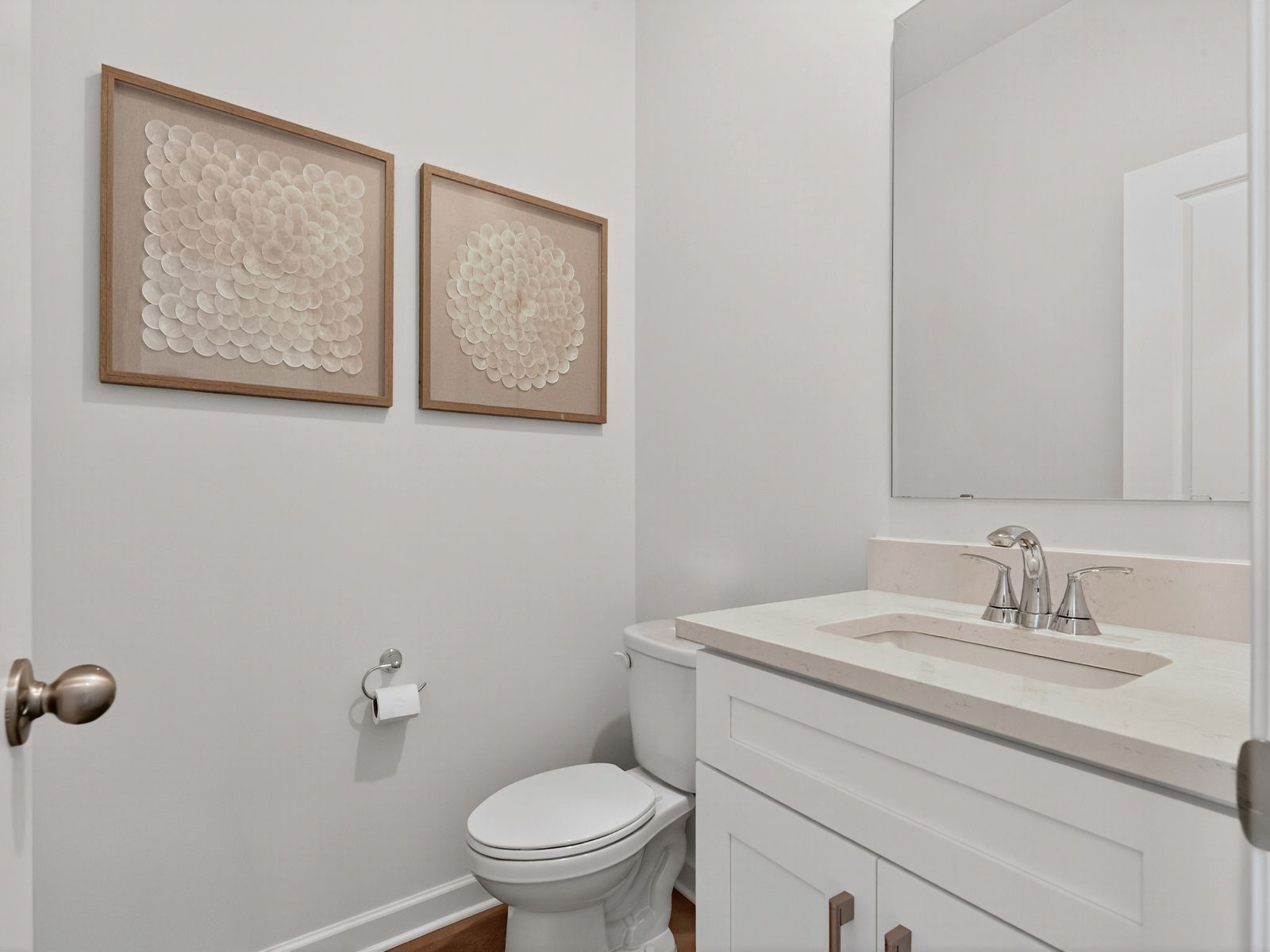 The half bathroom is conveniently located on the first floor for guests.