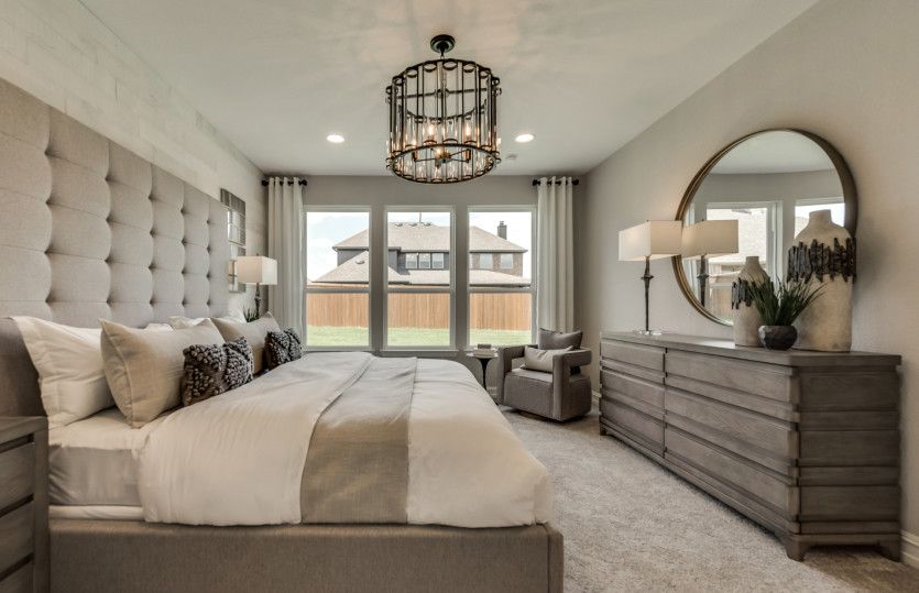 Large windows and recessed lighting in owner's suite