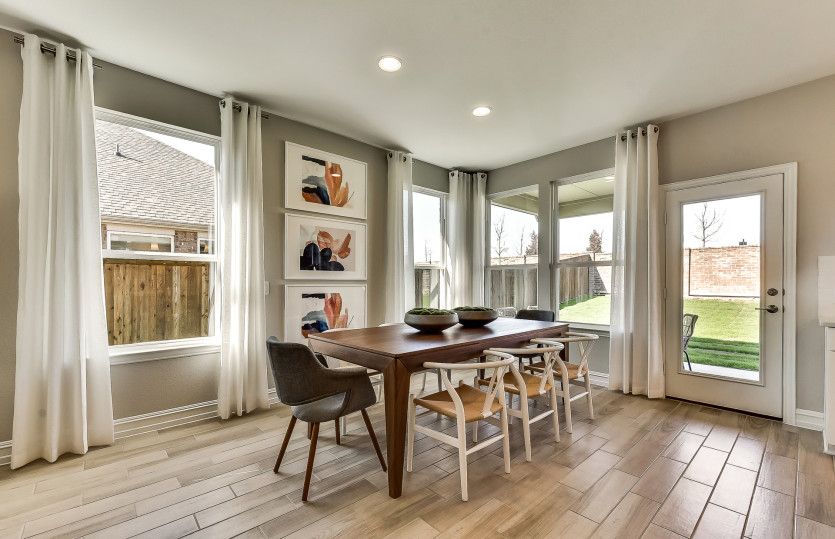 Dining area with large windows and access to covered patio