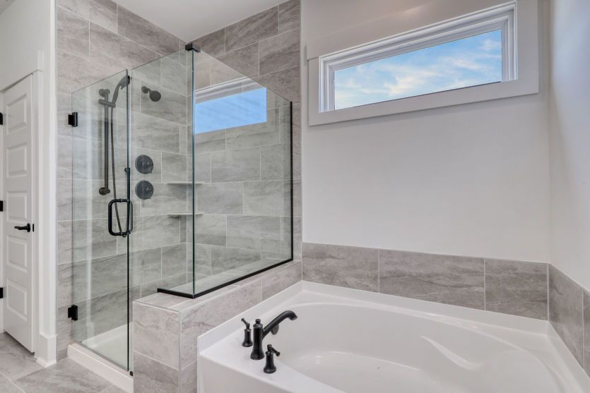 Private owner’s bathroom featuring a walk-in shower and elegant finishes.