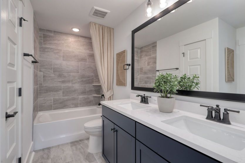Convenient secondary bathroom with sleek design details.