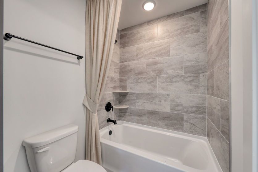 Well-appointed bathroom with modern fixtures and ample storage.