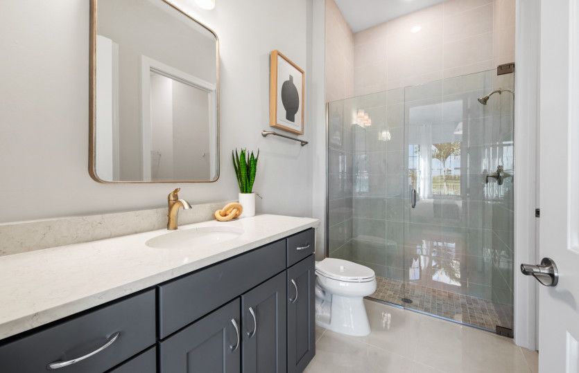 Secondary bathroom with glass shower door enclosure