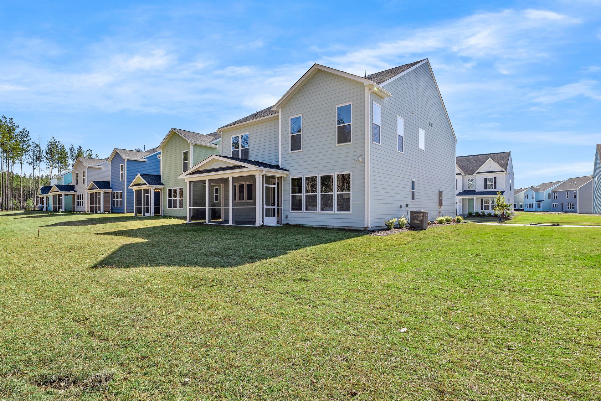 A row of houses are sitting next to each other on a lush green field.