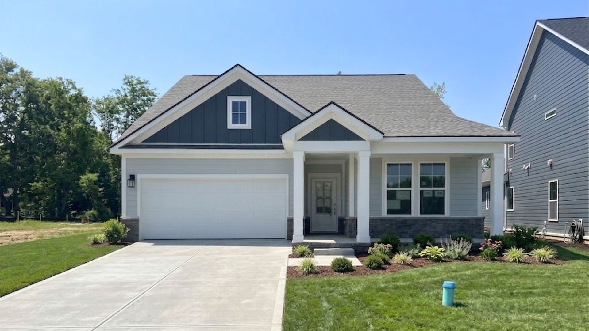 Chelsea Plan Exterior:Home with two-tone blue siding and accents, covered front porch and entry